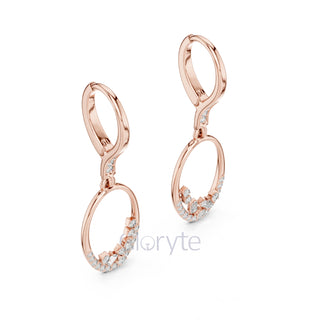 Rose gold earrings with small diamonds on a white background, branded 'Trollbeads'.